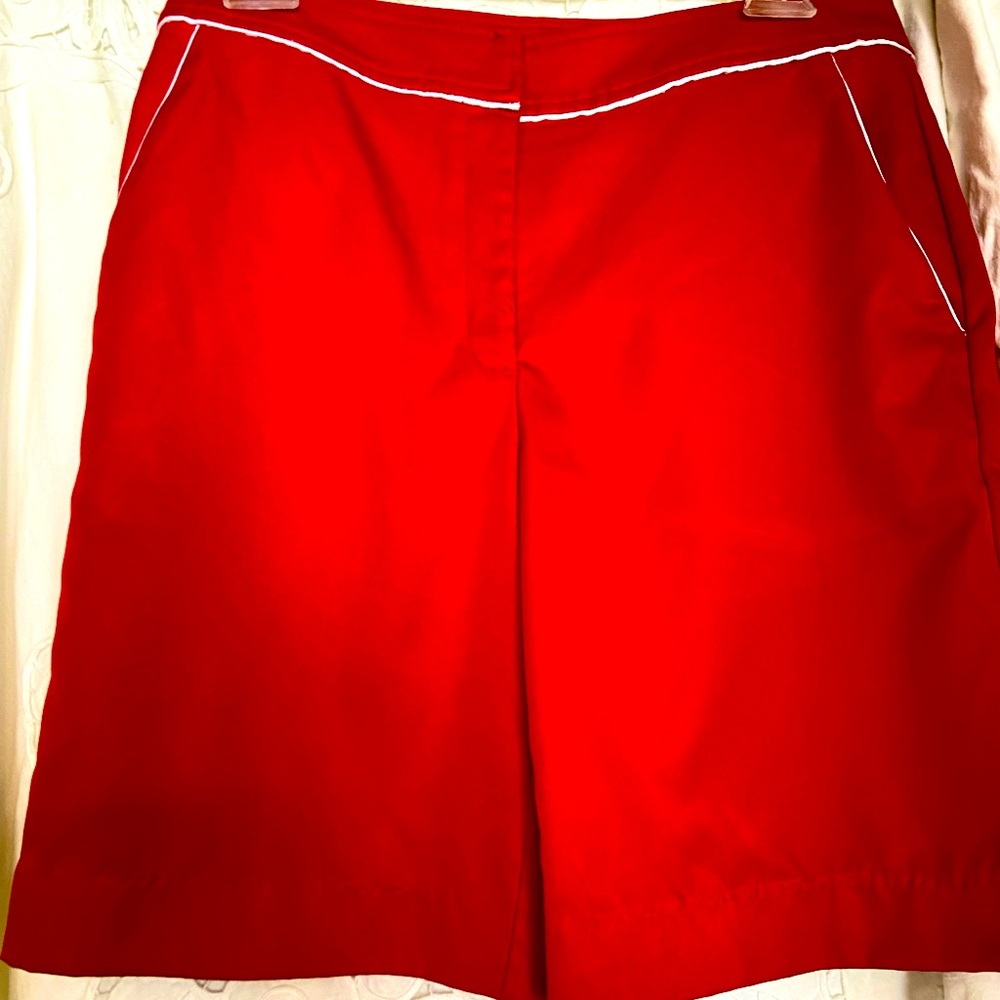 True red Izod shorts with white piping trim.